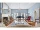 Spacious living room featuring hardwood floors, fireplace, and a grand piano at 927 Fishburne Rd, Pinopolis, SC 29469