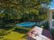 Inviting kidney-shaped pool surrounded by lush landscaping at 927 Fishburne Rd, Pinopolis, SC 29469