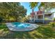 Inviting kidney-shaped pool surrounded by lush landscaping at 927 Fishburne Rd, Pinopolis, SC 29469