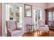 Bright sitting room with French doors, hardwood floors, and pink wingback chairs at 927 Fishburne Rd, Pinopolis, SC 29469