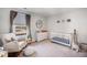 Peaceful Bedroom with crib, rocking chair and natural decor at 9702 Roseberry St, Ladson, SC 29456