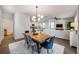 Open concept dining room with wood table, view of kitchen and living room at 9702 Roseberry St, Ladson, SC 29456