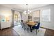 Dining room with wood table, blue and gray chairs, and modern chandelier at 9702 Roseberry St, Ladson, SC 29456