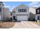 Two-story home with gray siding and a two-car garage at 9702 Roseberry St, Ladson, SC 29456