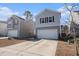 Two-story house with gray siding, white garage door, and landscaping at 9702 Roseberry St, Ladson, SC 29456