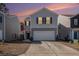 Two-story house with gray siding, white garage door, and landscaping at 9702 Roseberry St, Ladson, SC 29456