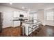 Modern kitchen with white cabinets, granite countertops, and island at 9702 Roseberry St, Ladson, SC 29456