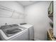 Functional laundry room with washer, dryer, and shelving at 9702 Roseberry St, Ladson, SC 29456