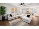 Spacious living room with L-shaped sofa, large rug, and hardwood floors at 9702 Roseberry St, Ladson, SC 29456