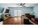 Light-filled living room with hardwood floors, fireplace, and sliding glass doors at 1101 Reserve Way, Summerville, SC 29485