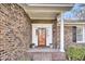 Inviting front entrance with a brick walkway and a charming covered porch at 114 Boone Dr, Summerville, SC 29485