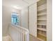 Upstairs hallway with built-in shelves and linen closet at 1141 Shadow Lake Cir # H, Mount Pleasant, SC 29464