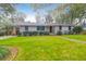 Ranch style home with gray brick and well-manicured lawn at 1159 Wyndham Rd, Charleston, SC 29412
