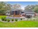 Back exterior view of the house with a screened porch and patio at 1159 Wyndham Rd, Charleston, SC 29412