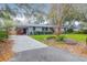 Front exterior view of the house with driveway and landscaping at 1159 Wyndham Rd, Charleston, SC 29412