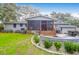 Back exterior view of the house with a screened porch and patio at 1159 Wyndham Rd, Charleston, SC 29412