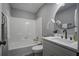 Modern bathroom with a white tub and vanity at 117 Hummingbird Ave, Ladson, SC 29456