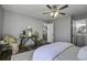 Bedroom with ceiling fan, gray walls, and access to a bathroom at 117 Hummingbird Ave, Ladson, SC 29456