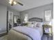Bedroom with neutral decor, wicker headboard, and ensuite bathroom at 117 Hummingbird Ave, Ladson, SC 29456