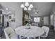 Bright dining area with round table and view into living room and kitchen at 117 Hummingbird Ave, Ladson, SC 29456