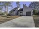 Gray house with a large driveway and mature trees at 117 Hummingbird Ave, Ladson, SC 29456