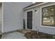 Dark-stained front door with a brick walkway at 117 Hummingbird Ave, Ladson, SC 29456