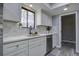 White kitchen cabinets, quartz countertops, and a farmhouse sink at 117 Hummingbird Ave, Ladson, SC 29456