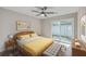 Bedroom with a queen-size bed and yellow bedding, next to patio at 1202 Waterwood Dr, Goose Creek, SC 29445