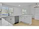 Modern white kitchen with stainless steel appliances and quartz counters at 138 Green Pond Hwy, Walterboro, SC 29488