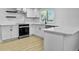 Sleek white kitchen with stainless steel appliances and island at 138 Green Pond Hwy, Walterboro, SC 29488
