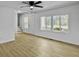Living room with hardwood floors, ceiling fan, and large windows at 138 Green Pond Hwy, Walterboro, SC 29488
