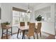 Bright dining room features a wood table, woven chairs, and a stylish light fixture at 1779 Tennyson Row # 5, Mount Pleasant, SC 29466