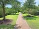 Brick-paved walkway lined with lush trees and landscaping at 1779 Tennyson Row # 5, Mount Pleasant, SC 29466