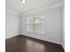 Bright bedroom with dark hardwood floors and a large window at 187 Weeping Cypress Dr, Moncks Corner, SC 29461