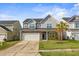 Two-story house with gray siding, stone accents, and a two-car garage at 187 Weeping Cypress Dr, Moncks Corner, SC 29461