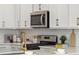 Kitchen detail showing modern microwave and gold faucet at 203 Abercom Place Dr, Moncks Corner, SC 29461