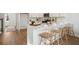 Modern kitchen with white cabinets, marble countertops, and island with seating at 203 Abercom Place Dr, Moncks Corner, SC 29461