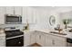 Modern kitchen with white cabinets, gas range, and stainless steel appliances at 203 Abercom Place Dr, Moncks Corner, SC 29461