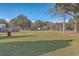 Large grassy backyard with mature trees and a wooden fence at 208 Catfish Landing Cir, Bonneau, SC 29431