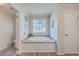 Bathroom with a built-in soaking tub and a modern look at 208 Catfish Landing Cir, Bonneau, SC 29431