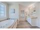 Bathroom with a garden tub, double vanity, and wood-look floors at 208 Catfish Landing Cir, Bonneau, SC 29431