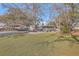 Spacious front yard with large trees and a covered boat storage area at 208 Catfish Landing Cir, Bonneau, SC 29431