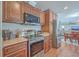 Modern kitchen with stainless steel appliances and wood cabinets at 208 Catfish Landing Cir, Bonneau, SC 29431