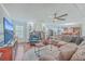 Open living room with sectional sofa, hardwood floors, and view to kitchen at 208 Catfish Landing Cir, Bonneau, SC 29431