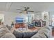 Spacious living room with a fireplace, sectional sofa, and large TV at 208 Catfish Landing Cir, Bonneau, SC 29431