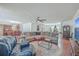 Open living room with sectional sofa, hardwood floors, and view to kitchen at 208 Catfish Landing Cir, Bonneau, SC 29431