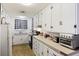 White kitchen cabinets, gas stove, and built in microwave at 2108 Ridge Church Rd # A & B, Summerville, SC 29486