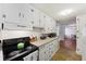 Kitchen with white cabinets, gas stove, and view to dining area at 2108 Ridge Church Rd # A & B, Summerville, SC 29486