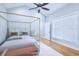 Virtually staged bedroom with canopy bed and light wood floors at 25 Sheppard St, Charleston, SC 29403