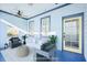 Virtually staged porch with seating and a yellow door at 25 Sheppard St, Charleston, SC 29403